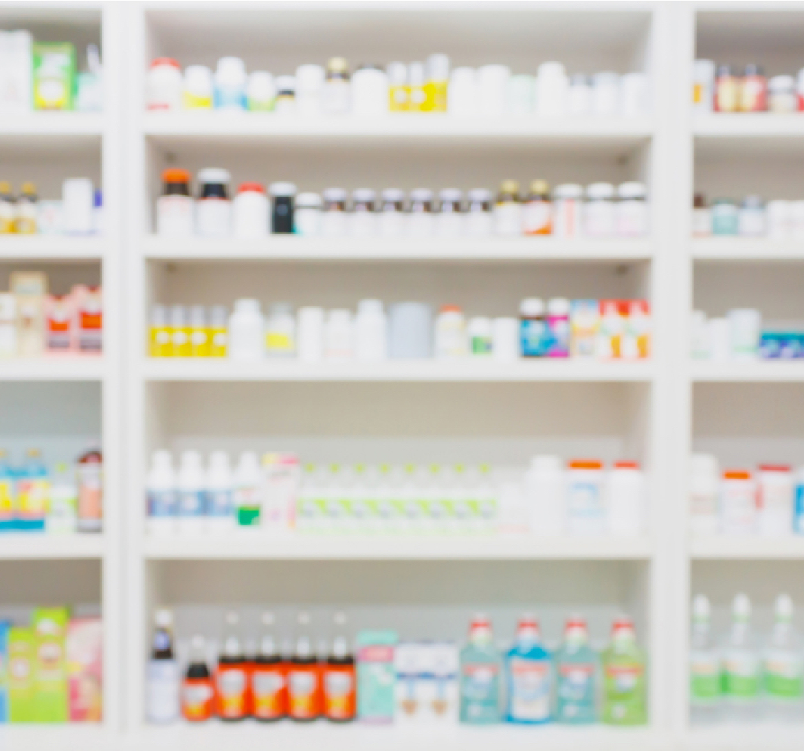 Slightly blurred view of shelves of medication bottles.